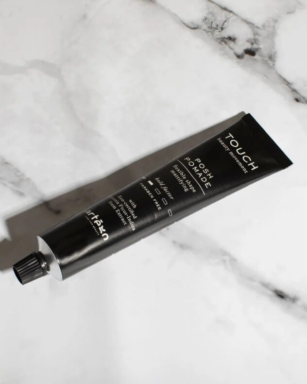 Touch Posh Pomade styling product with sleek packaging, offering strong hold, shine, and smooth, defined hair styling results.